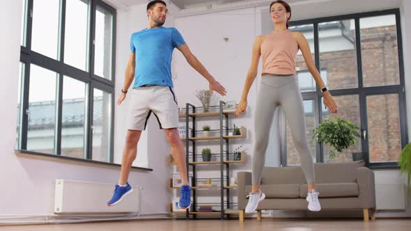 Happy Couple Exercising at Home