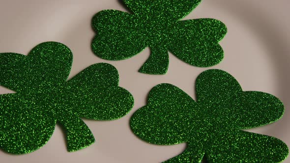 Rotating stock footage shot of St Patty's Day clovers on a white surface - ST PATTYS 005