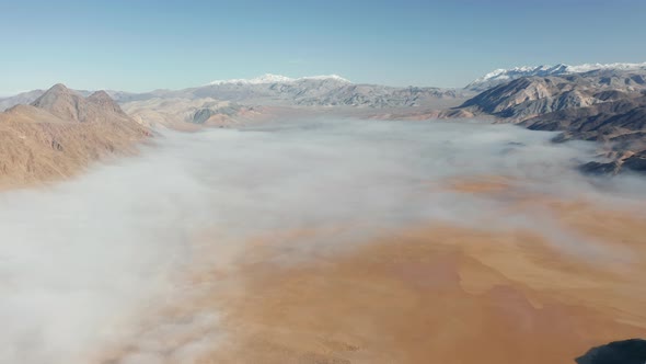 Ancient Lake Bed Is Covered By Fog Clouds Surrounded By Snowy Mountain Peaks