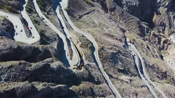 winding road with cars santorini port