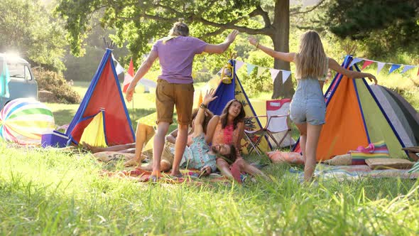 Hipster couple sitting down with their friends