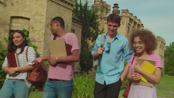 Multiracial Group of Cheerful Students Walking and Laughing Outdoors