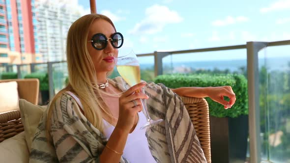 A beautiful young woman sipping a glass of champagne