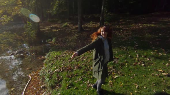 Female hiker dancing at Fusine lake, Italy