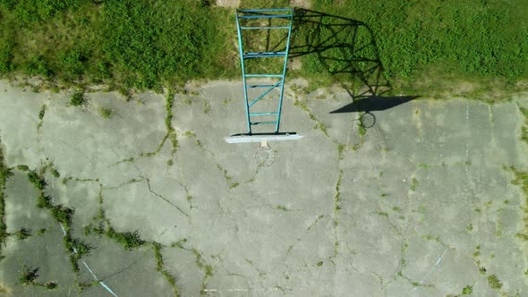 Old Basketball Backboard. Made From Boards. Peeling Paint And A Battered Basket.