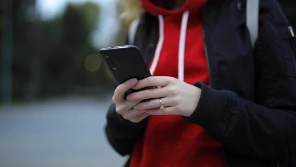 Female Hands Using Phone in Evening City