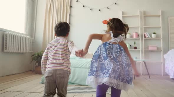 Young Kids Having a Fun Time Jumping on the Bed Brother and Sister Jump Play Together Happy Children