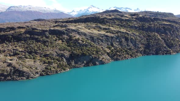 Top aerial drone panoramic view Beautiful snowy mountains landscape and a cristal clear river along