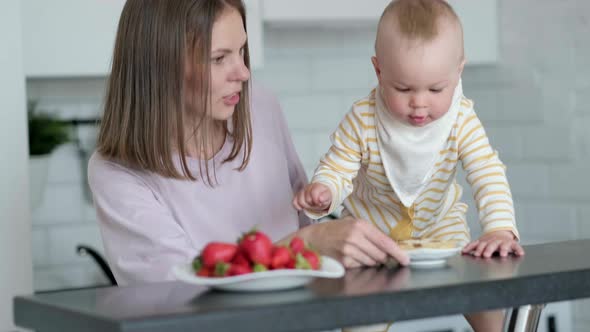 Mother and Baby Cooking on Kitchen at Home