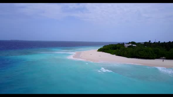 Aerial drone shot travel of idyllic island beach break by blue sea with clean sandy background of a 