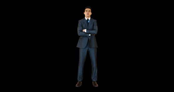 Young businessman standing with arms crossed