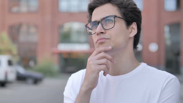 Outdoor Portrait of Young Man Thinking New Plan