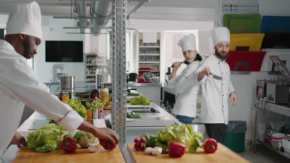 Team of Professional Chefs Doing Funny Moves with Knives