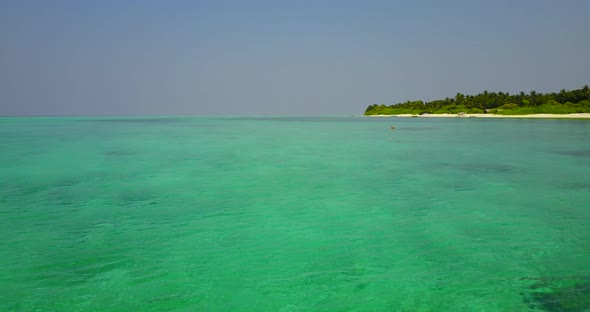 Tropical birds eye abstract shot of a white sand paradise beach and aqua turquoise water background 