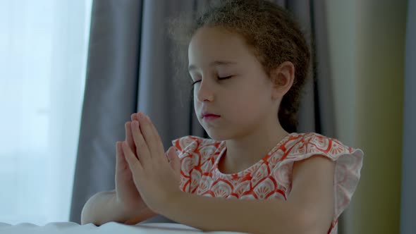 Little Girl is Praying in Her Room