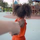 Pov Shot of Little Afro Girl Holding Mother Hand Walking on Playground - VideoHive Item for Sale