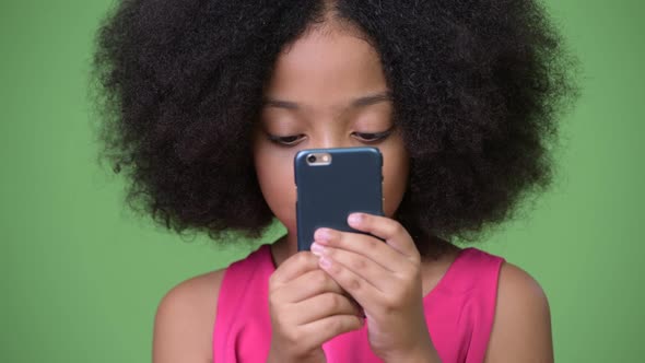 Young Cute African Girl with Afro Hair Using Phone