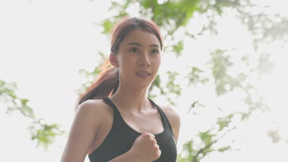 Asian young beautiful sport woman  exercise by running on street in evening sunset in public park.