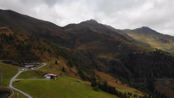 Lush Green Forest And The Rugged Landscape Of Mountain Range In Rauris, Austria. aerial