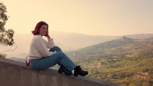 Beautiful girl with Red Short Hair on the mountains