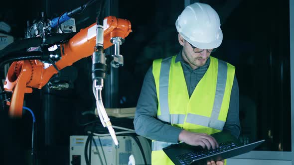 Construction Engineer is Inspecting a Robotic Mechanism