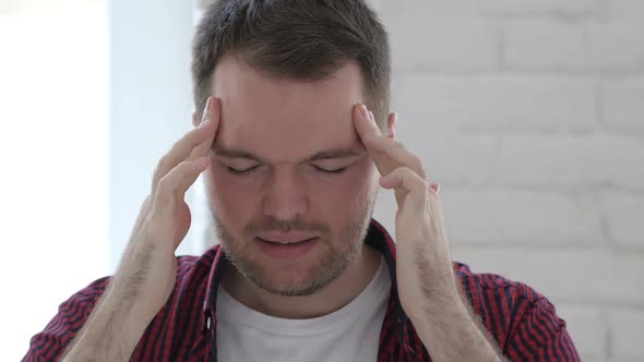 Headache Tense Young Man at Work in Office Library