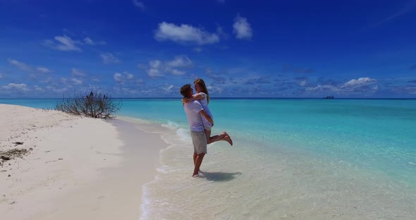 Romantic boy and girl on romantic honeymoon spend quality time on beach on sunny white sandy