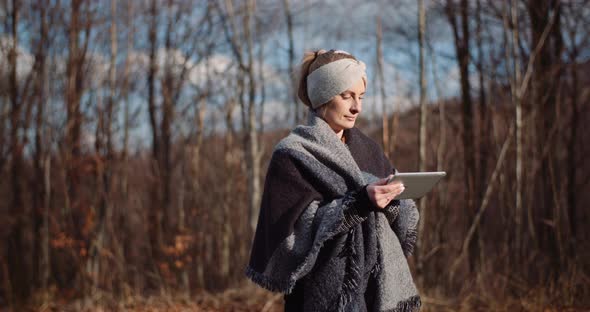 Woman Using Digital Tablet Outdoors on a Trip