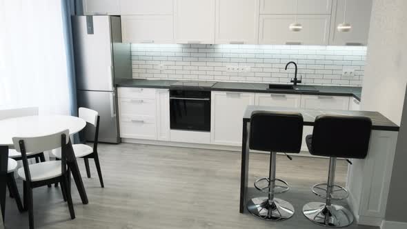 Scandinavian Design Minimalist Kitchen Interior. Light Interior of a White Kitchen in a Compact