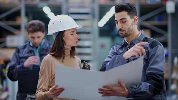 Young Handsome Middle Eastern Man and Beautiful Caucasian Woman Discussing Shipping Plan in