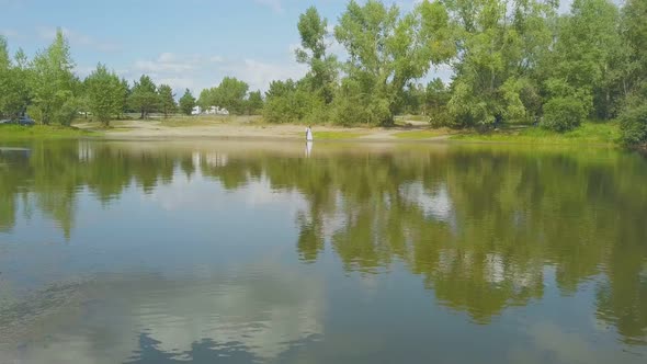 Newlywed Couple Rests Near Lake Against Road Upper View