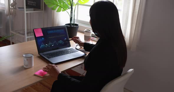 Young woman working inside office doing blockchain research - Business person using computer laptop