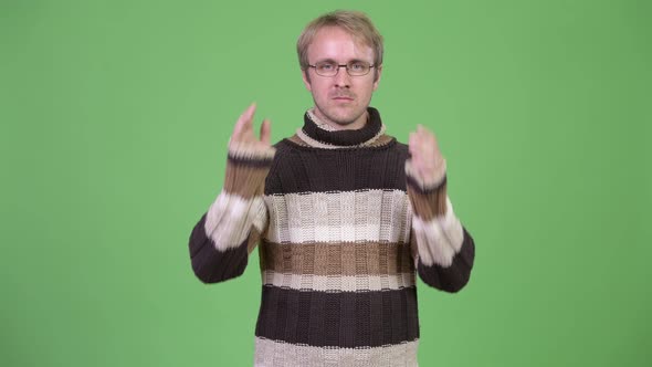 Studio Shot of Blonde Handsome Man Showing Three Wise Monkeys Concept