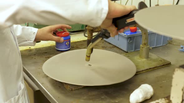 Solder a music vinyl record mold by a worker in a factory