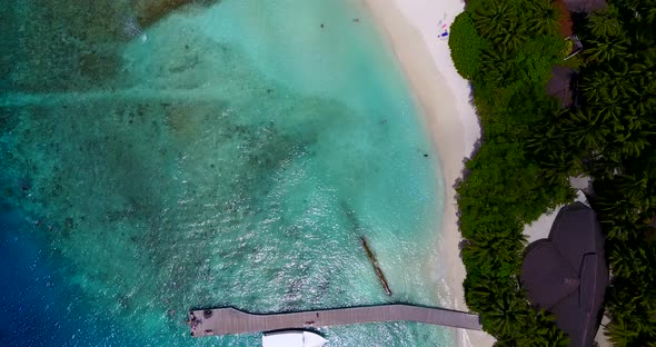 Natural overhead clean view of a summer white paradise sand beach and aqua blue water background in 