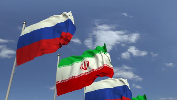 Waving Flags of Iran and Russia on Sky Background