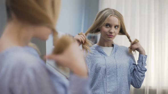 Pretty School Girl Trying Different Hairstyles in Mirror, Preparing for Party