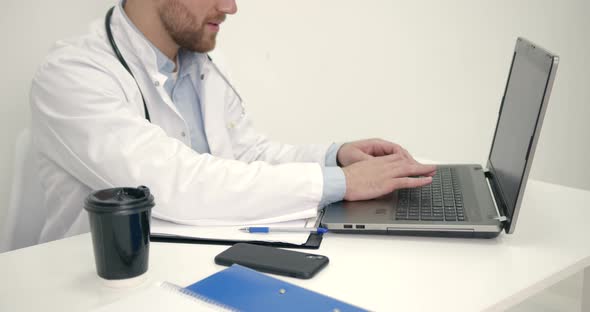 Male Doctor Work with Laptop at Office