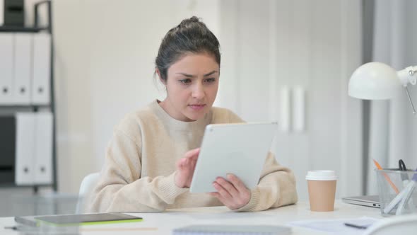 Indian Woman with Tablet Reacting To Loss 