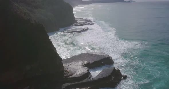 Stunning aerial morning flight over cliffs and stormy colorful ocean, Australia