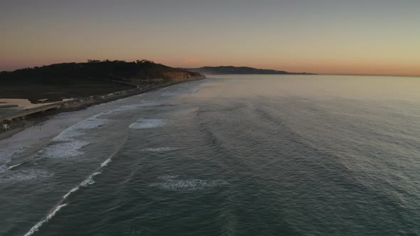 Vibrant Sunset over Waves Crashing on San Diego, California - Aerial