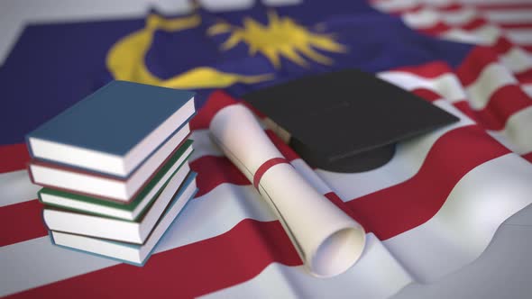 Graduation Cap and Diploma on the Flag of Malaysia alt