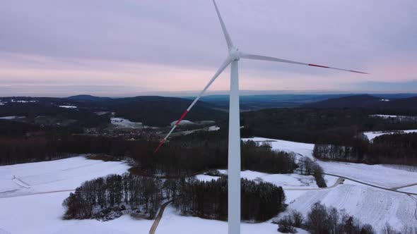 Aerial view of a wind farm in winter. Aerial view of rotating wind turbines.