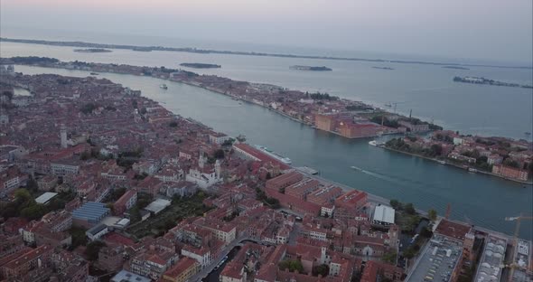 Wide aerial shot of moving towards Giudecca from above at dusk, Venice, Italy