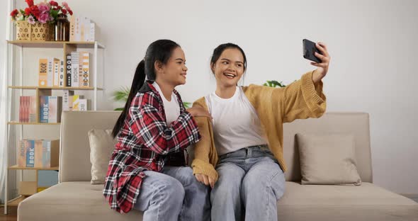 Asian twin selfie with smartphone