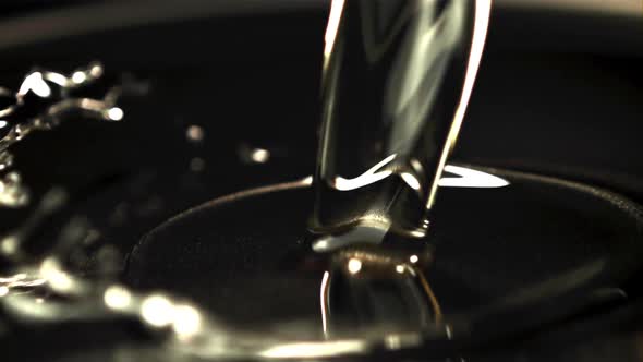 Super Slow Motion Oil Pours Into the Pan for Frying