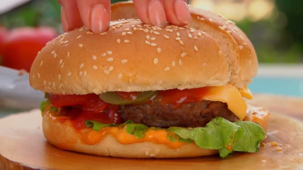 Knife Cuts Into Half a Delicious Hamburger