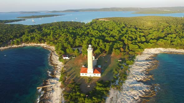 Aerial view of lighthouse, Croatia on forested shore