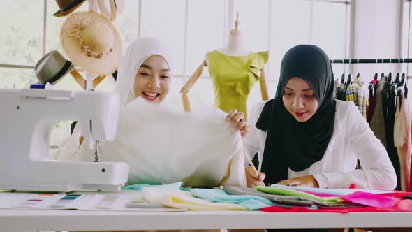 Muslim women fashion designers are in process of creating new clothes collection.