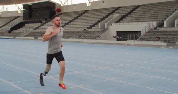 Caucasian disabled male athlete with running blade training and running